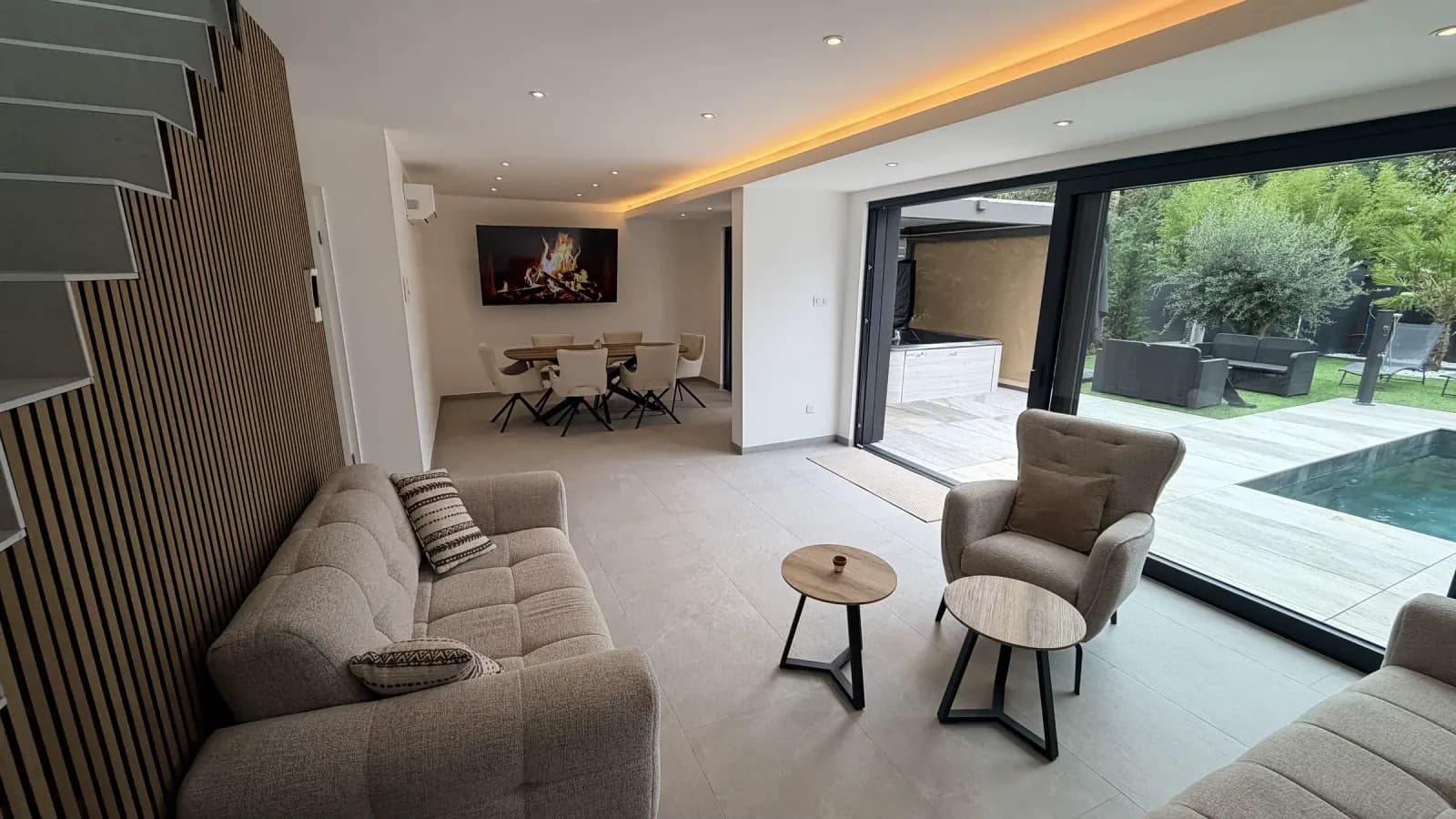 Salon de Villa La Buena Vida avec canapé et baie vitrée vers la piscine